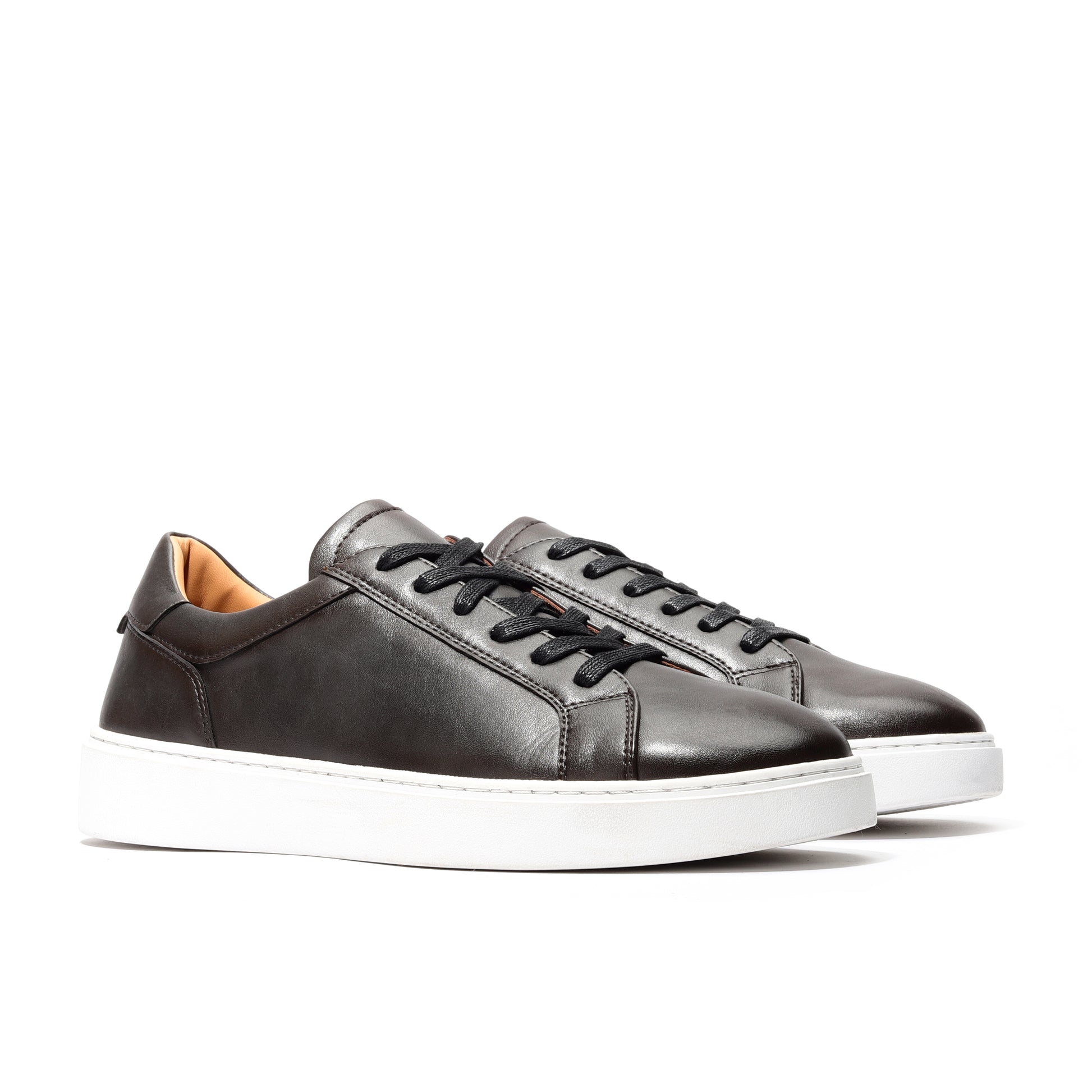 Angled view of black luxury leather sneakers for men with versatile low-top style.