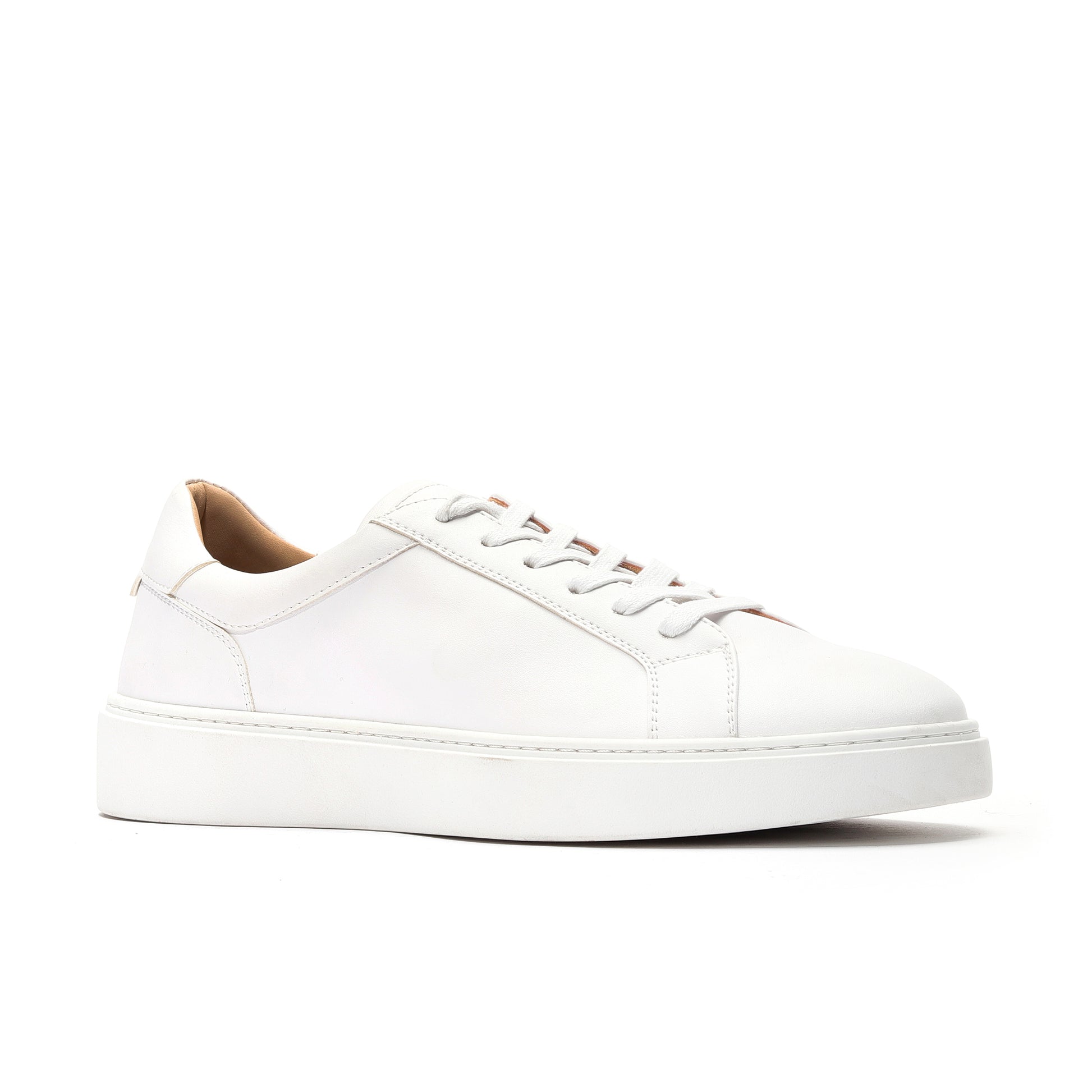 Side profile of white premium leather sneakers showcasing sleek stitching and flexible outsole.