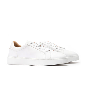 Angled view of white leather sneakers for men with low-top design and cushioned comfort.