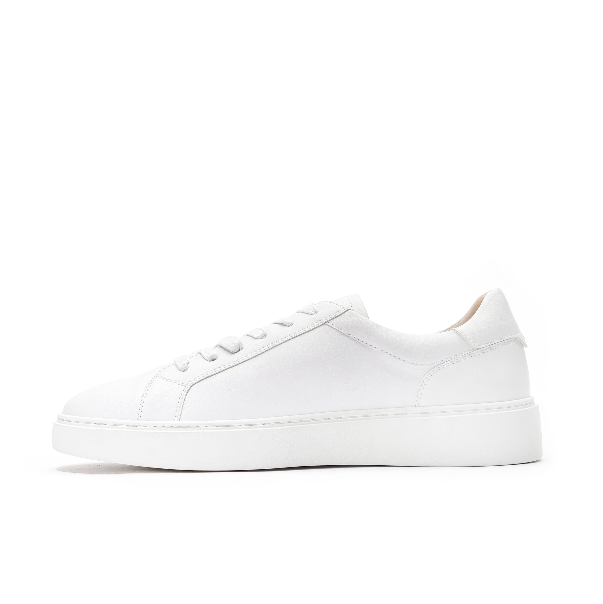 Lifestyle shot of casual white leather low-top sneakers for everyday wear.