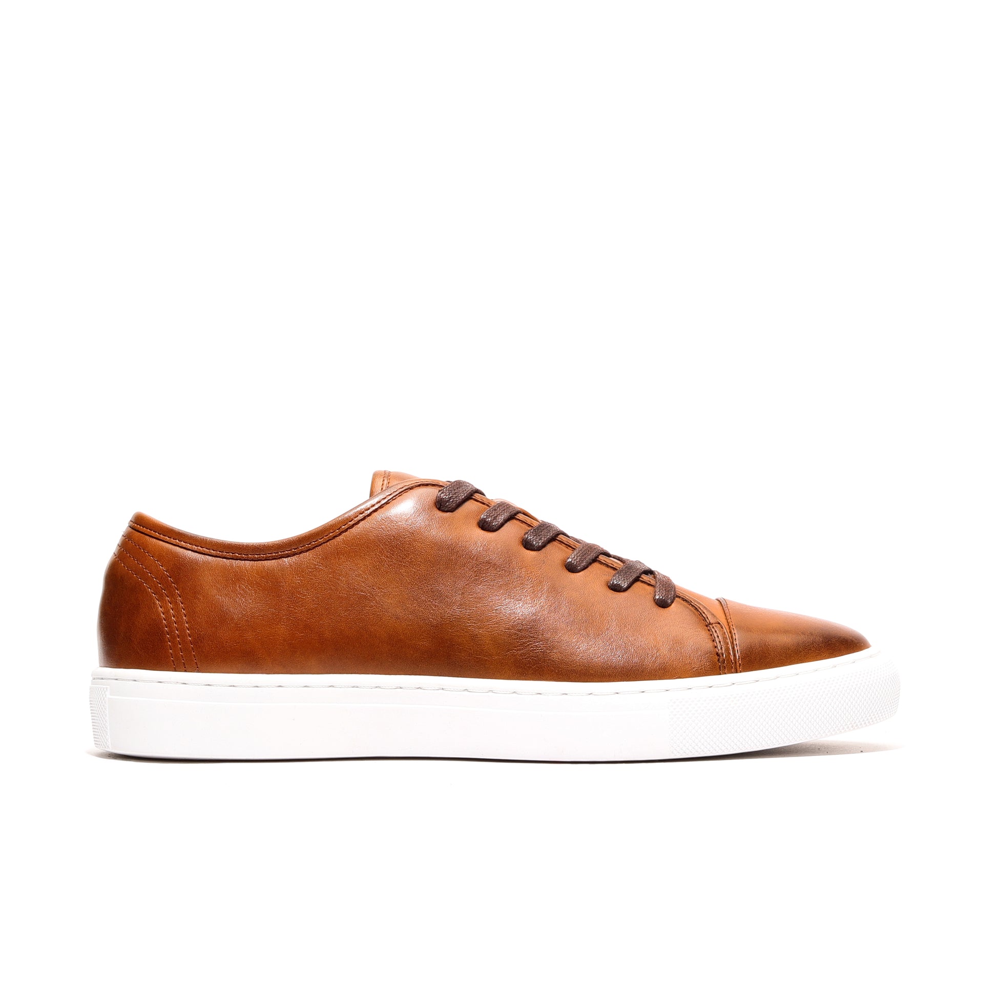 Lifestyle shot of cognac casual leather sneakers for men, designed for versatile everyday wear.