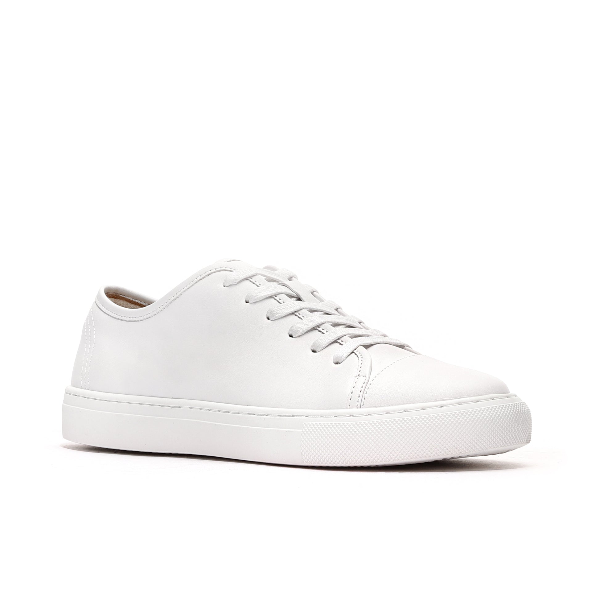 Side profile of white luxury leather sneakers for men, crafted with cap-toe design and flexible outsole.