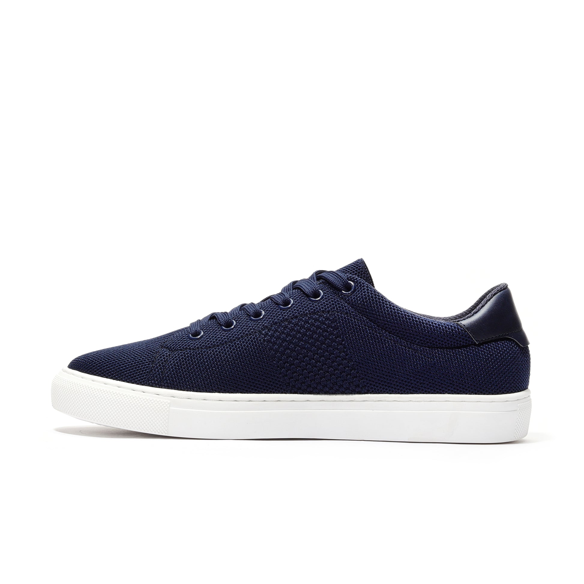 Navy sport knit sneaker side view featuring a breathable mesh upper, cushioned sole, and streamlined design for enhanced comfort and performance. Perfect for everyday wear, workouts, or casual outings, offering a stylish and functional fit.