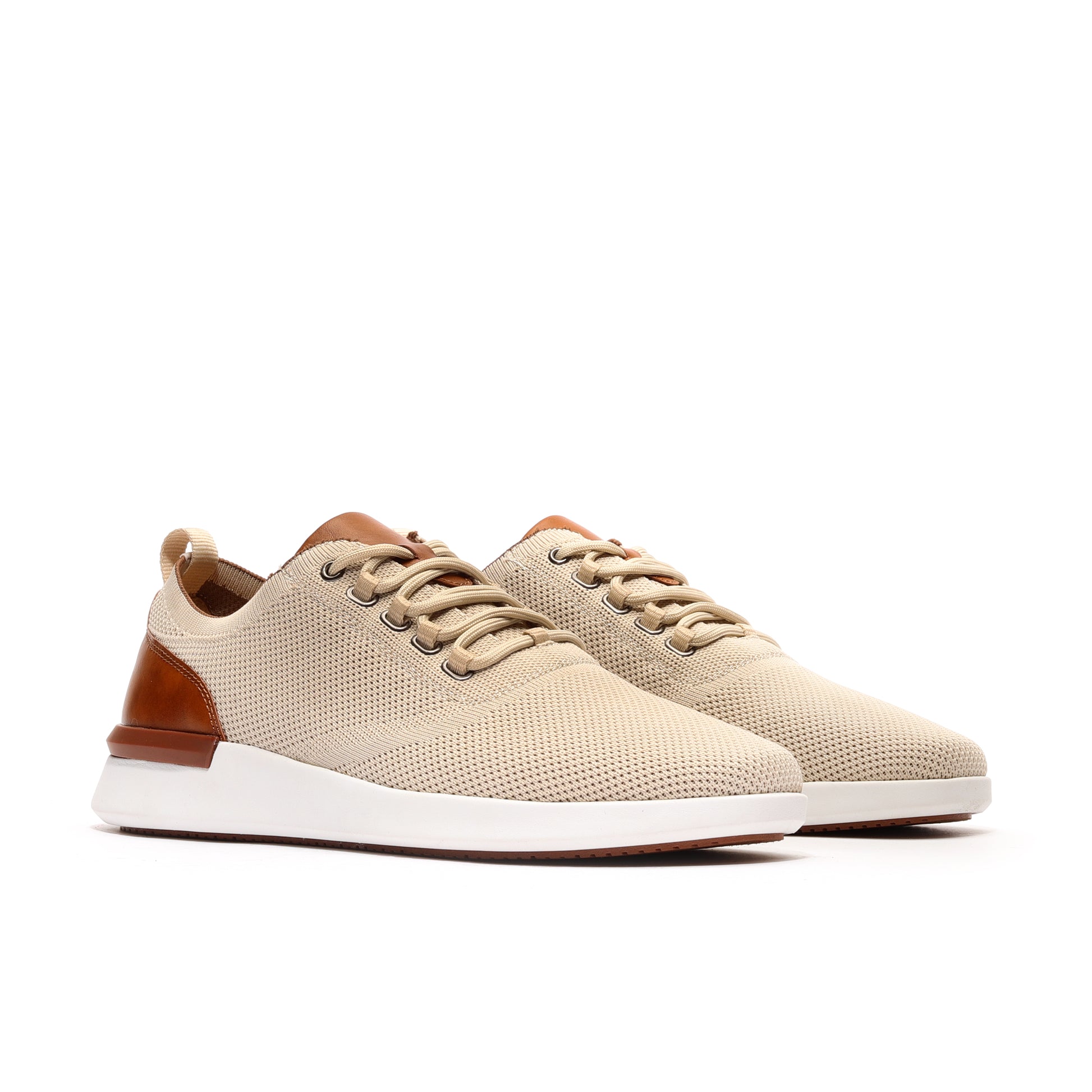 Angled profile of two sand-colored men's athleisure sneakers, highlighting their stylish design and versatility for everyday wear and casual outings.