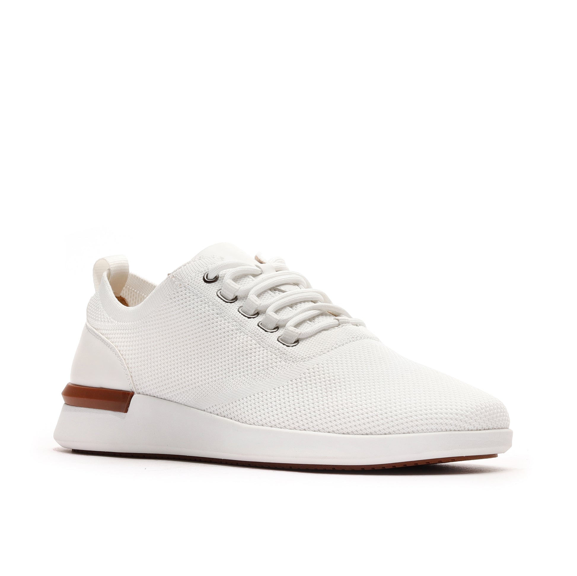 Angled view of white men’s athleisure shoes, showcasing a modern design and lightweight construction.