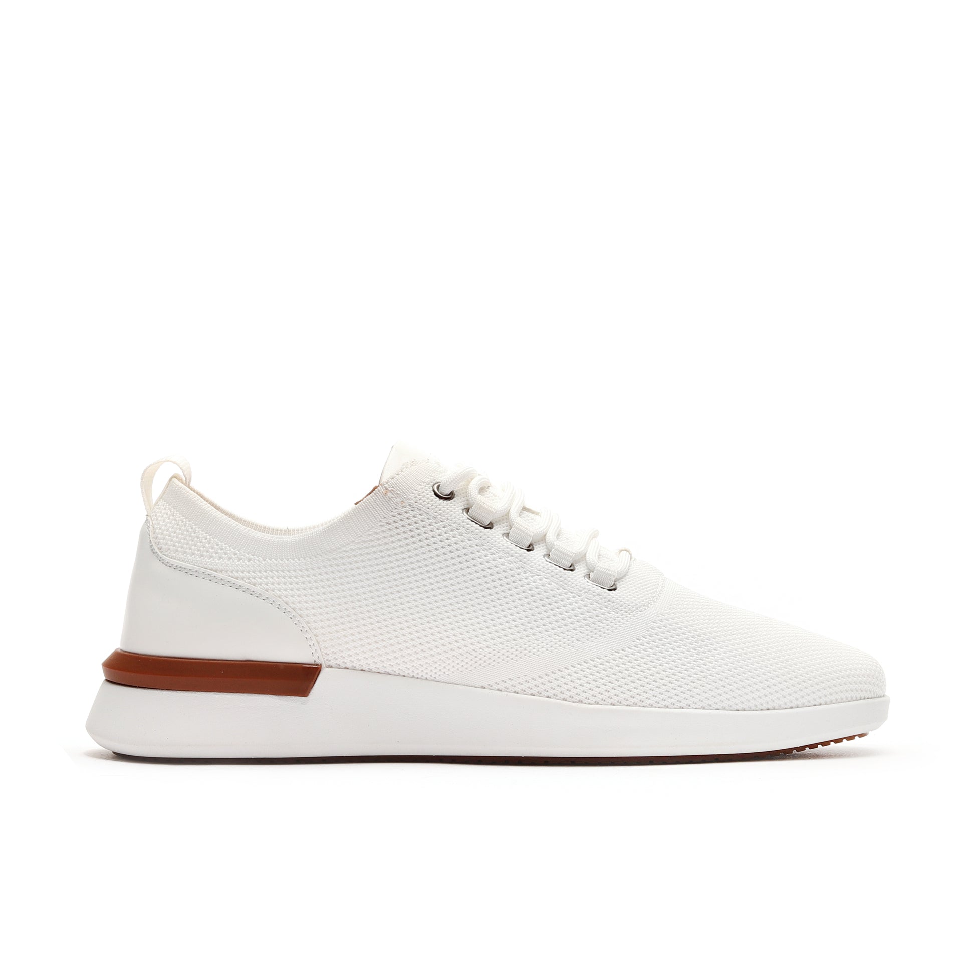 Side profile of white men’s athleisure shoes, featuring a sleek design and comfortable fit.