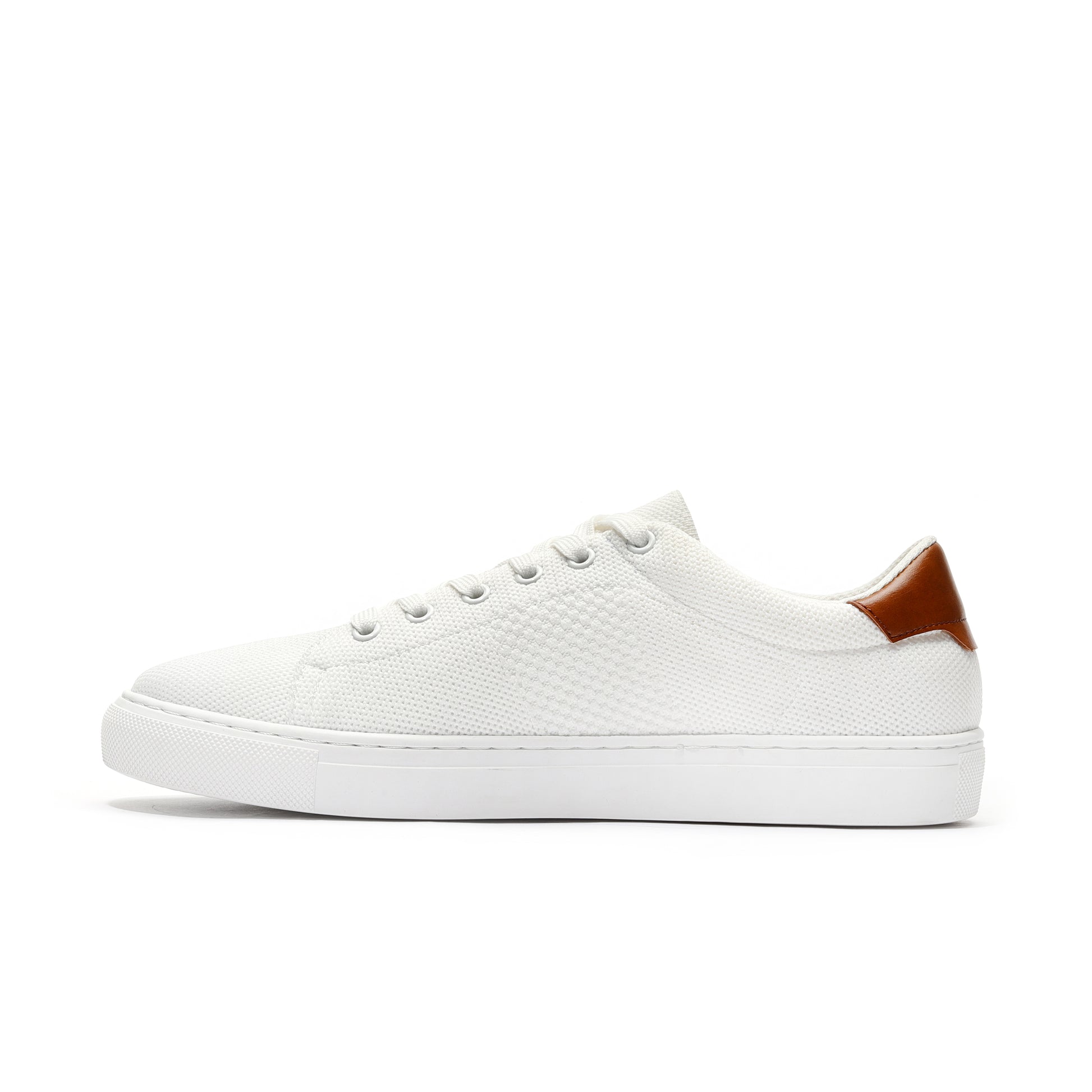 White sport knit sneaker side view featuring a breathable mesh upper, cushioned sole, and sleek, flexible design. Ideal for running, workouts, or casual wear, offering superior comfort, durability, and a modern athletic style.